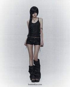 Person with long black hair wearing a black tank top and shorts on a white background