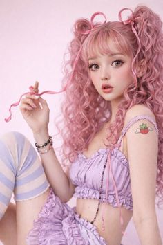 Woman with pink curly hair in a lavender top and ruffled skirt
