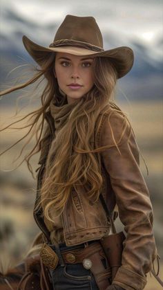Woman in a cowboy hat and leather jacket with long flowing hair outdoors