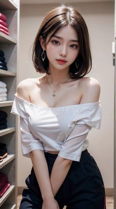 Woman with short hair wearing an off-shoulder top and jewelry indoors