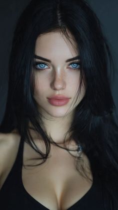Woman with striking blue eyes and black hair, showing cleavage