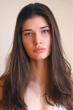 Woman with long brown hair and blue eyes in a natural light portrait