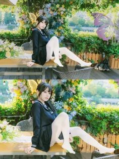 Woman in a school uniform and white tights sitting outdoors with a floral background