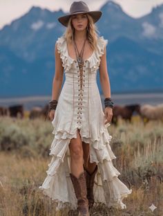Woman in a cowboy hat and ruffled dress with cowboy boots in a field
