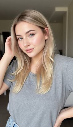 Blonde woman in a grey t-shirt with soft lighting indoors