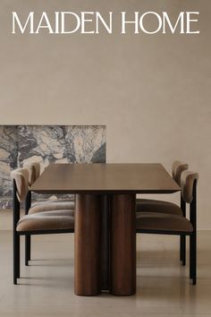 Modern dining room with a wooden table, velvet chairs, and a marble accent wall