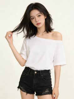Woman with short black hair in a white t-shirt and black shorts