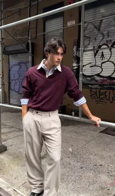 Man in a maroon polo shirt and khaki pants on an urban street