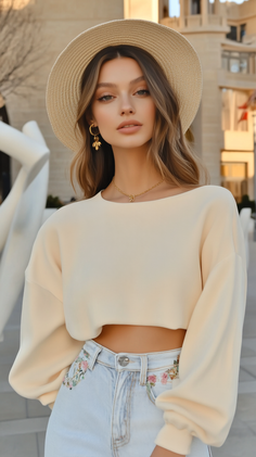 Woman in a straw hat and crop top with embroidered jeans outdoors