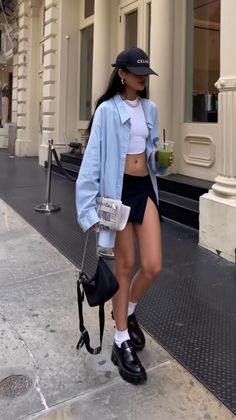 Woman in a crop top and mini skirt walking on a city street