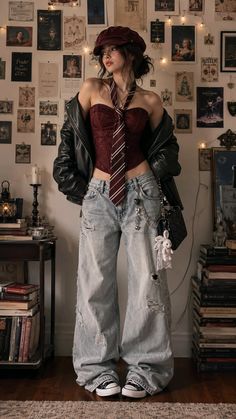 Woman in a corset top, distressed jeans, and leather jacket in a room with wall decor