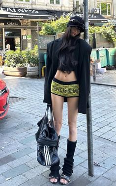 Woman in an oversized blazer and short shorts on a city street