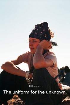 Person wearing a bandana and t-shirt outdoors in bright sunlight