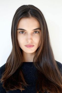 Woman with long dark hair and natural makeup in a portrait shot