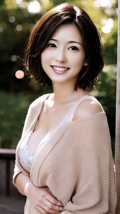 Smiling woman with short brown hair and exposed cleavage outdoors