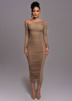 Woman in a ruched off-shoulder bodycon dress with an updo and gold earrings