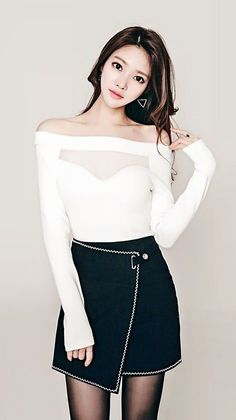 Woman in an off-shoulder top with sheer fabric and a black mini skirt