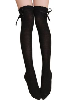 Pair of legs wearing black thigh-high socks with bows and scalloped edges