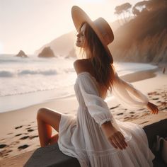 Woman in a white dress and straw hat on a beach at golden hour