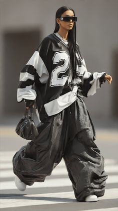 Person in an oversized jersey and baggy pants walking on a street