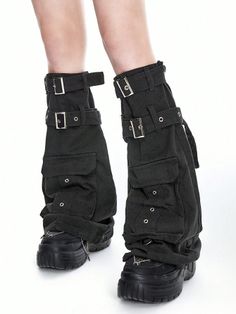 Person wearing black cargo pants with buckles and platform shoes