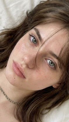 Close up portrait of a woman with green eyes and freckles