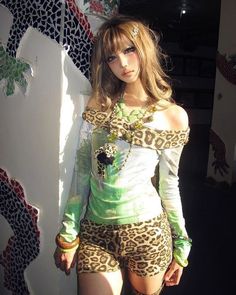 Woman in leopard print top and shorts with long hair and dramatic lighting