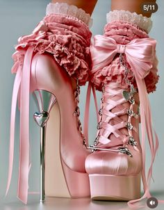Pink satin platform heels with bows, ribbons, and heart charms