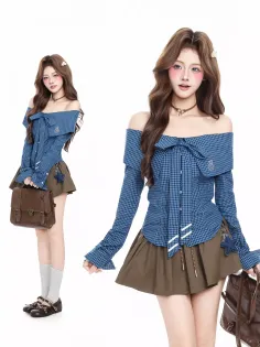 Woman in a plaid off-shoulder top and mini skirt with a brown bag
