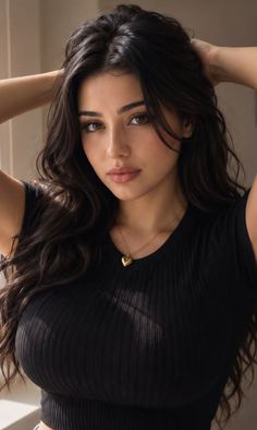 Woman with long wavy dark hair wearing a black top and heart necklace
