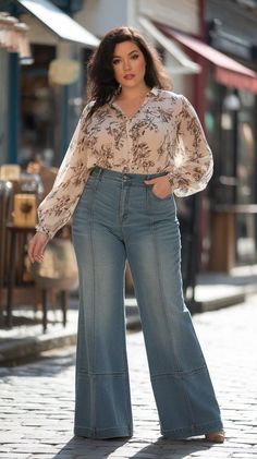 Woman in a floral blouse and wide leg jeans standing on a street