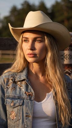 Woman in a cowboy hat and denim jacket during golden hour