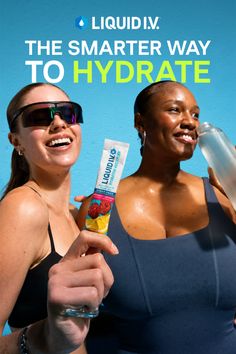 Two smiling women in sports bras, one holding a hydration drink mix packet