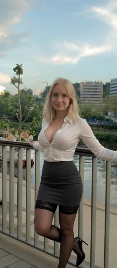 Blonde woman in a white shirt, mini skirt, and thigh-high stockings outdoors