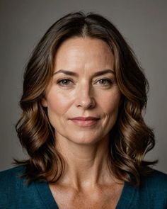 Woman with brown wavy hair and green eyes in a portrait shot