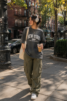 Woman in cargo pants and an oversized t-shirt walking on a city street