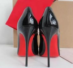 Pair of black patent leather high heels with red soles