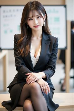 Woman in a business suit with cleavage and pantyhose, sitting indoors
