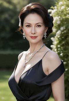 Woman in a black dress with jewelry and an updo hairstyle outdoors