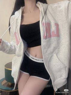 Person in an open hoodie, black crop top, and underwear, showing midriff