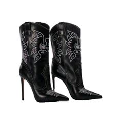 Pair of black leather cowboy boots with white stitching and high heels