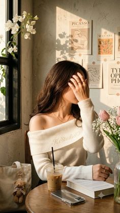 Woman with long hair in an off-shoulder top at a coffee shop during golden hour