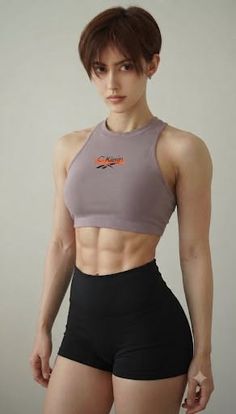 Woman with short hair and muscular body wearing a sports bra and shorts