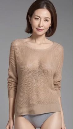 Woman in a sheer knitted sweater and gray underwear in a studio shot