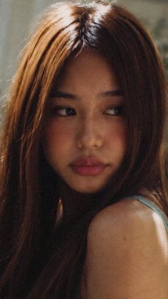 Woman with long brown hair and soft lighting on her face