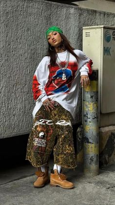 Woman in a green bandana and oversized shirt with leopard print pants outdoors