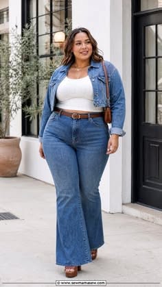 Woman in a denim jacket and flared jeans walking outdoors