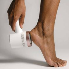Hand using an electric callus remover on a foot