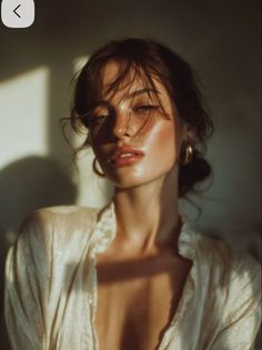 Woman with messy hair and freckles in soft golden hour lighting