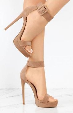 Pair of nude platform high heels with ankle straps on a white background
